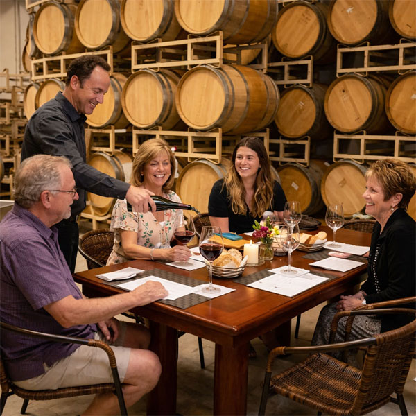 Guests enjoying a seated winery lunch during the Custom Crush Experience in the Willamette Valley